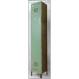 A vintage mid century Industrial slim metal locker with full length door having vented top raised