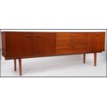 A 1970's Avalon teak sideboard of good proportions being raised on turned legs with a central bank