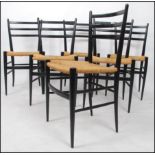 A set of 6 mid century ebonised and rattan weave dining chairs in the manner of Gio Ponti.