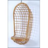 A 1970's hanging / swing egg chair having rattan weave construction to a wire work frame.