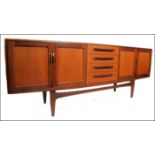 A good retro 1970's long and low G plan Fresco teak sideboard enclosed by moulded panelled door