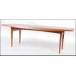 A 1960's teak wood Gordon Russell rectangular coffee / occasional table raised on tapered supports