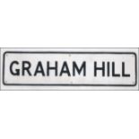 A cast iron painted road sign in the manner of Worboys for ' Graham Hill ' 92cm wide x 23cm high