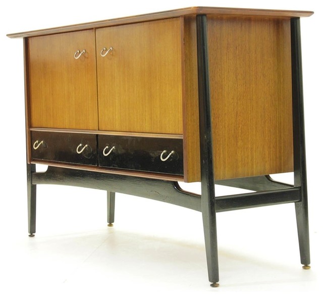 A 1970's G-Plan Librenza tola wood sideboard raised on an ebonised suspension set base with