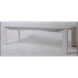 A 20th century modernist coffee - occasional table raised on shaped metal base painted white (