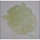 A Chinese celadon jade belt buckle carve