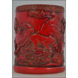 A cinnabar red Chinese brush pot depicti