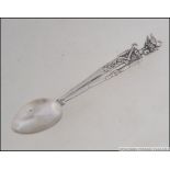 An Egyptian silver hallmarked tea spoon with figural stem marked with date letter in Egyptian