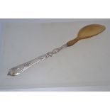 A silver and horn large table serving spoon. The rococo handle in silver with horn bowl. unmarked.