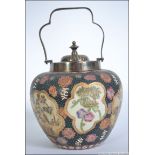 A 20th century Oriental Japanese biscuit barrel with silver plated cover and swing handle.