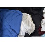 A group of vintage scholar gowns to include blue and black with Mortar boards