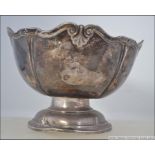 A Victorian silver hallmarked Walker & Hall rose bowl raised on terraced base with leaf shaped cast