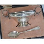 A silver hallmarked twin handled feeding bowl and matching spoon set in it's original leather