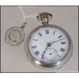 A silver early 20th century crown wind pocket watch with enamel face having faceted hands and