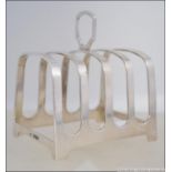 A silver hallmarked toast rack by Mappin & Webb. Hallmarked for Sheffield 1954. Weight 91.6g.