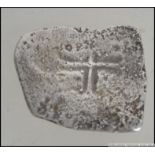 A silver Mexican 8 real coin ' piece of eight ' purported to be from the wreck of the Johanna.