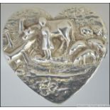 A silver hallmarked pill box in the form of a heart having unusual farming scene cast in relief to