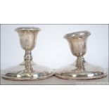 A near pair of silver hallmarked stub filled candlesticks having a Birmingham assay and dating to