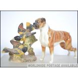 A Beswick figure of a boxer dog along with a Beswick group figure of a pair of Baltimore Oriels