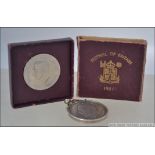 A 1951 Festival of Britain George VI five shilling crown coin complete in the box together with a