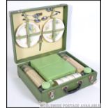 A vintage mid 20th century Brexton picnic hamper case in a green finish.