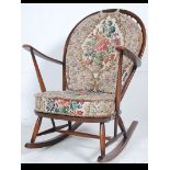 An Ercol beech and elm wood Windsor pattern rocking chair / armchair raised on sleigh runners with