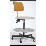 A vintage mid 20th century industrial machinist swivel chair having padded seat and adjustable