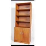 A 1970's G-Plan teak wood upright bookcase room divider having bank of drawers to the base with