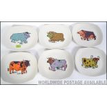 A set of original retro 1970's Beefeater plates each with a different style of cow pattern and