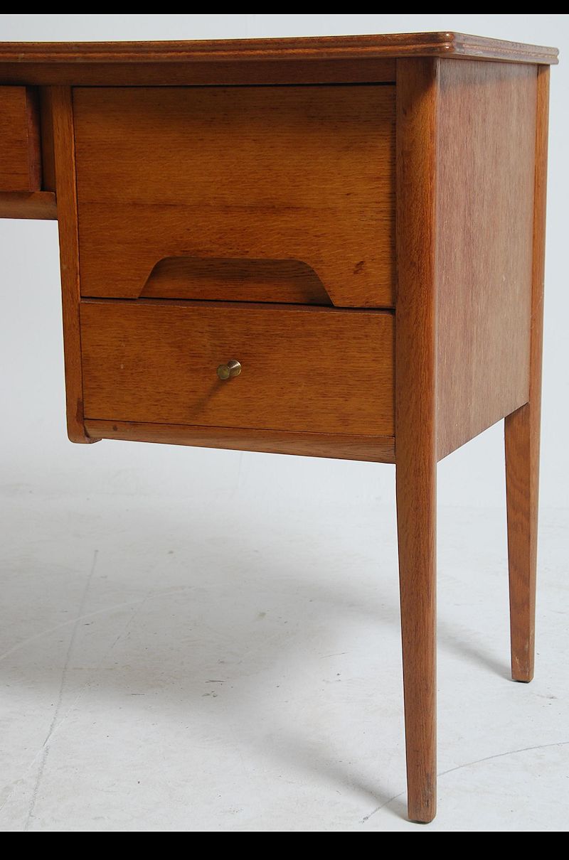 A 1970's Youngers teak wood desk raised on shaped supports having floating pedestals with recessed - Image 4 of 5