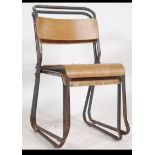 A pair of vintage 20th century tubular painted framed industrial stacking chairs having ply panel