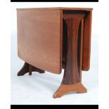 A retro 20th century G-Plan teak drop leaf dining table having splayed foot frame,