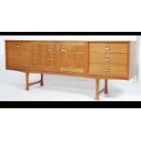 A 1970's retro Danish influenced teak wood sideboard raised on tapered legs with cupboards and