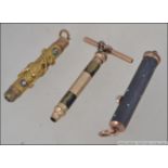 3 yellow metal early 20th century propelling pencils to include a Perry and Co metamorphic 3 draw
