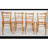 A set of 4 mid century Ben Chairs dining chairs having orange pad seats being raised on angular