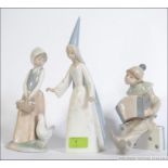 A collection of Lladro ceramic figurines to include Boy Clown with Concertina on Dominoes,