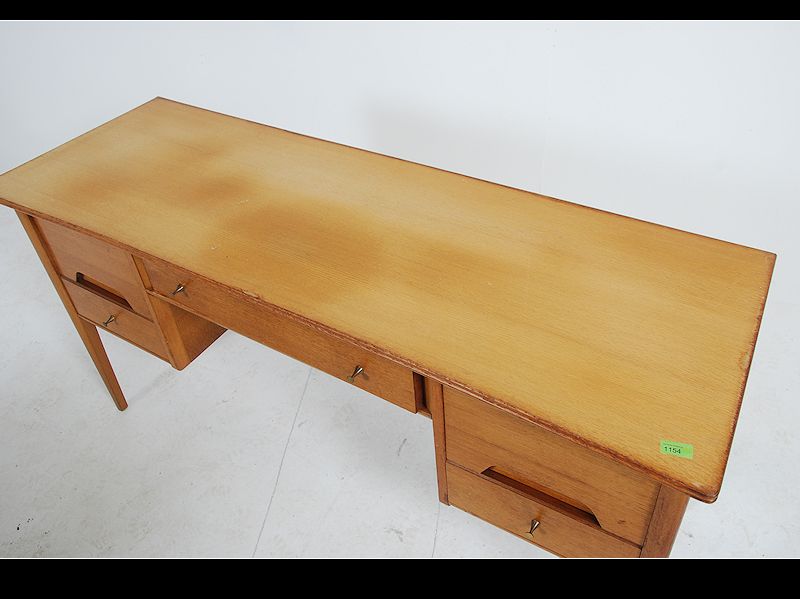 A 1970's Youngers teak wood desk raised on shaped supports having floating pedestals with recessed - Image 5 of 5