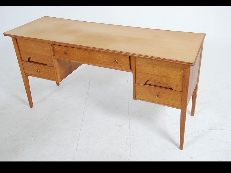 A 1970's Youngers teak wood desk raised on shaped supports having floating pedestals with recessed - Image 2 of 5