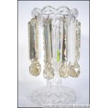 A Victorian cut glass table lustre raised on half moon base with drop lustres surrounding.