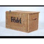 A stunning 20th century large whicker basket come laundry basket with lid attached by leather
