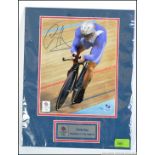 An official signed and mounted photograph of Sir Chris Hoy from the London Olympics before his