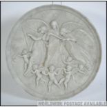 An early 20th century Parian ware roundel wall plaque being moulded in relief with classical scene