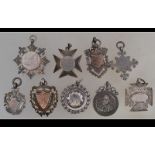 A collection of silver hallmarked armorial pocket watch fobs - plaques,