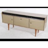 A mid century retro / vintage melamine sideboard dresser being raised on tapered legs with