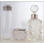 A silver ladies perfume bottle with cut glass being hallmarked for Robert Pringle & Sons, London.