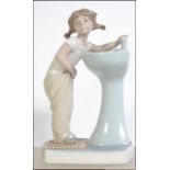 A Lladro ceramic figurine entitled ' Clean up time '. The figurine of girl at sink in towel.