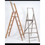 2 vintage wooden folding a-frame industrial ladders ideal as upcycled bookshelves.