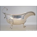 A silver hallmarked Mappin & Webb creamer raised on claw and ball feet. Hallmarked for London 1915.