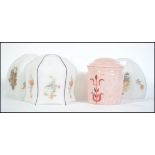 A collection of 1930's Art Deco glass light shades three decorated with floral patterns and the