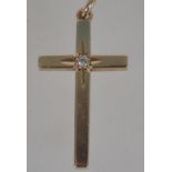 A hallmarked 9ct gold crucifix pendant with inset 2 pts diamond. Measures 3cms long and weighs 2.